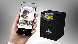 Smartphone scanning security label on black packaging